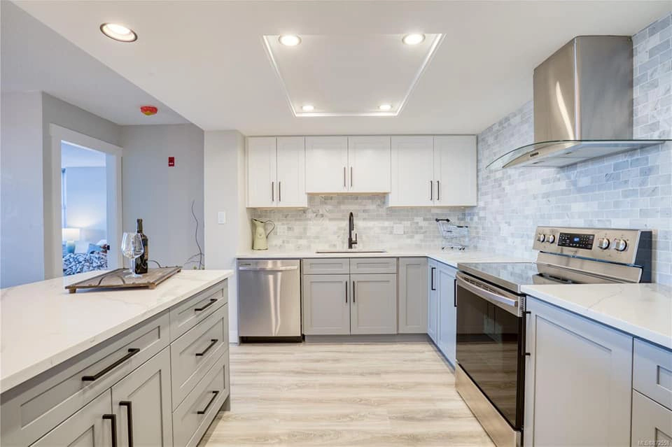 Detail of finished cabinetry, tile backsplash and flooring in a completed Right Call Contracting kitchen renovation